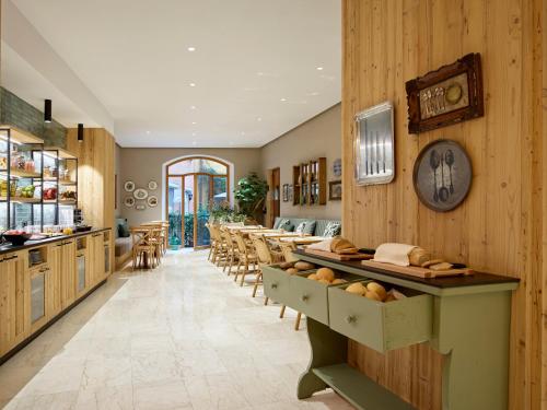 a restaurant with wooden walls and tables and chairs at Hotel America in Trento