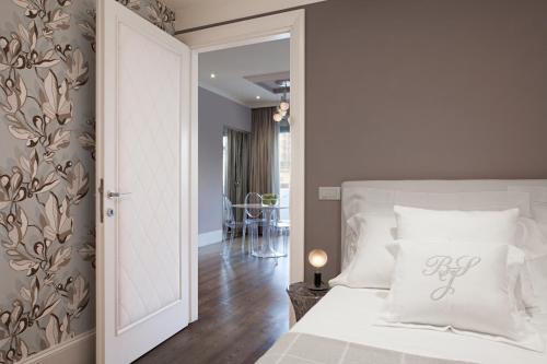 um quarto com uma cama branca e um quarto com uma mesa em UNYCA - River View Suite em Florença