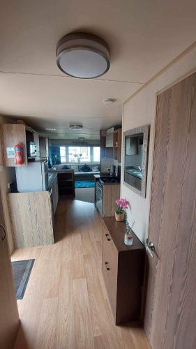 a living room with a kitchen and a room with a unintention at Rose bank Retreat in Hunmanby