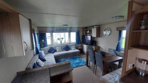 a living room with a couch and a table at Rose bank Retreat in Hunmanby