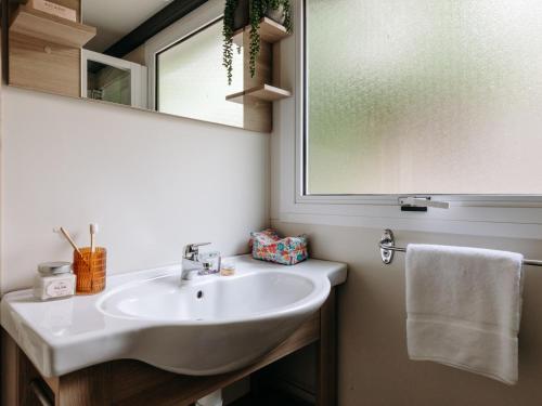 a bathroom with a sink and a mirror at Slow Village Anduze - Cévennes in Corbés