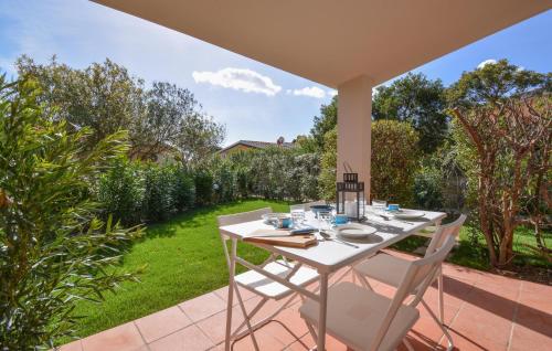 a white table and chairs on a patio at Bilocale in Costa Rei