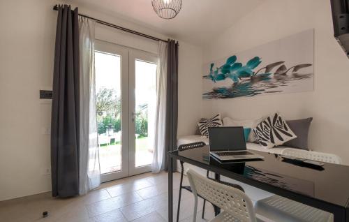 a room with a desk with a laptop on it at Bilocale in Costa Rei