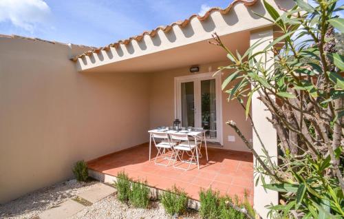 a patio with a table and chairs in a house at Bilocale in Costa Rei