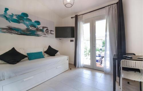 a bedroom with a bed and a sliding glass door at Bilocale in Costa Rei
