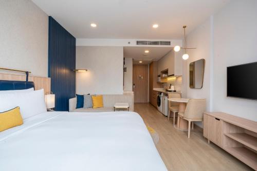 a hotel room with a bed and a kitchen at Staybridge Suites Bangkok Thonglor by IHG in Bangkok
