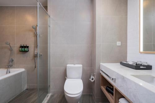 a bathroom with a toilet and a shower and a sink at Staybridge Suites Bangkok Thonglor by IHG in Bangkok