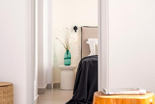 a room with a vase sitting on a table at Quartano Suites by Heliessa, Adults Only in Naousa