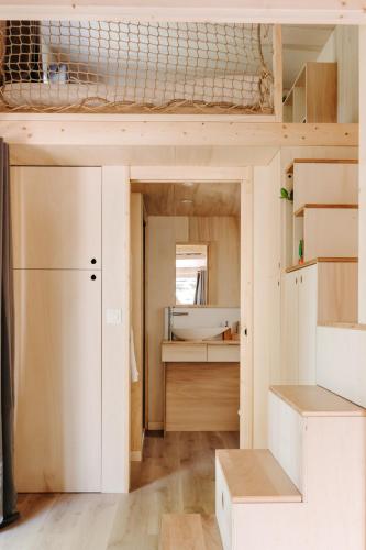 a room with a loft bed and a kitchen at Slow Village Anduze - Cévennes in Corbés