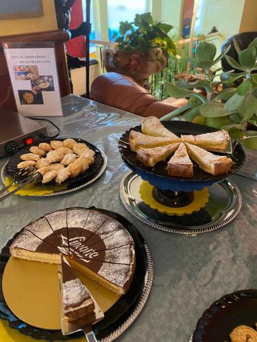 a table topped with plates of bread and pies at Hotel Napoleon in Lido di Jesolo