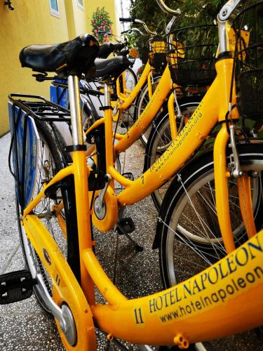 a group of yellow bikes parked next to each other at Hotel Napoleon in Lido di Jesolo