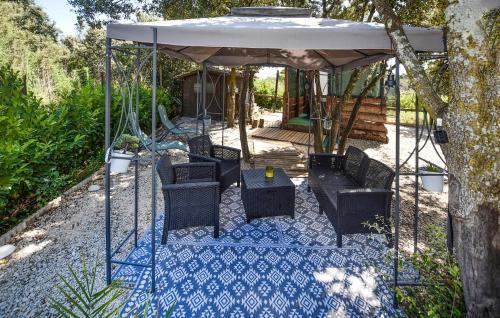 a gazebo with chairs and a table under it at Gorgeous Stacaravan in Pernes-les-Fontaines