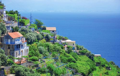 a group of houses on a hill next to the ocean at Beautiful Apartment In Raito With Wifi in Albori