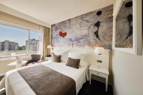 a hotel room with a bed and a large window at Hotel Joan Miró Museum in Palma de Mallorca