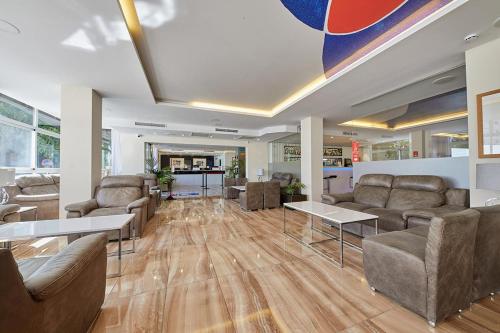 a lobby with couches and tables in a building at Hotel Joan Miró Museum in Palma de Mallorca