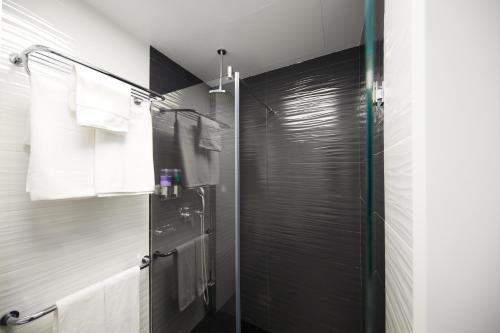 a bathroom with a shower with a glass door at Hotel Joan Miró Museum in Palma de Mallorca