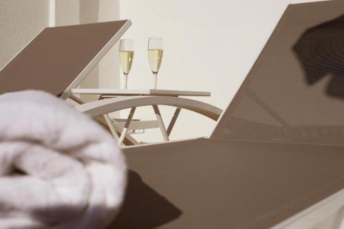 two glasses of champagne on a table with a laptop at Hotel Joan Miró Museum in Palma de Mallorca