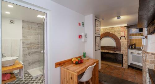 a bathroom with a sink and a counter with a sink at OurMadeira - Cottage do Mar, secluded in Arco da Calheta