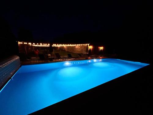 a large swimming pool lit up at night at MOULIN DE L'HOSTE in Larzac