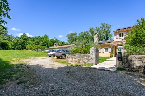 a house with a car parked in front of a driveway at Villa Lipa in Krnica