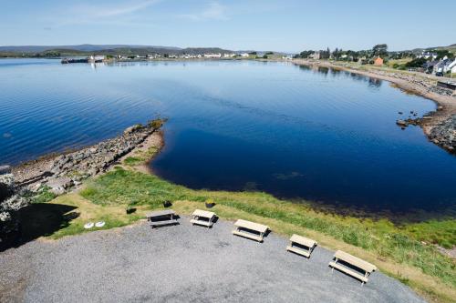 an aerial view of a lake with several benches at Aultbea Hotel in Achnasheen