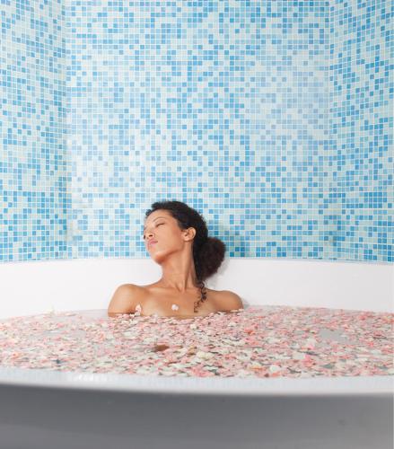 a woman is sitting in a bath tub at Kenzi Tower Hotel in Casablanca