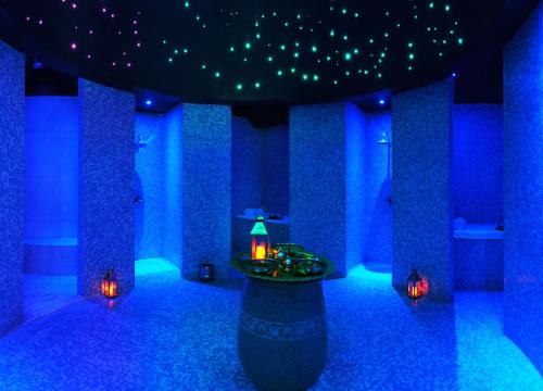 a blue room with a table and lights in it at Kenzi Tower Hotel in Casablanca