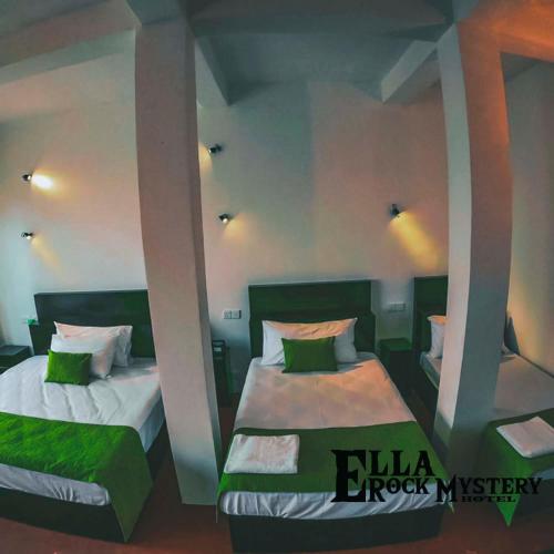 a bedroom with two beds with green pillows at Ella Rock Mystery Guest in Ella