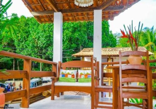 a porch with two chairs and a gazebo at Pousada Campestre in Trancoso