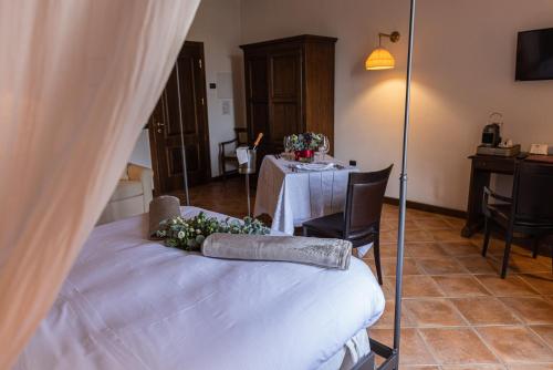 a room with a table and a bed with flowers on it at Al Castello Resort in Sillavengo