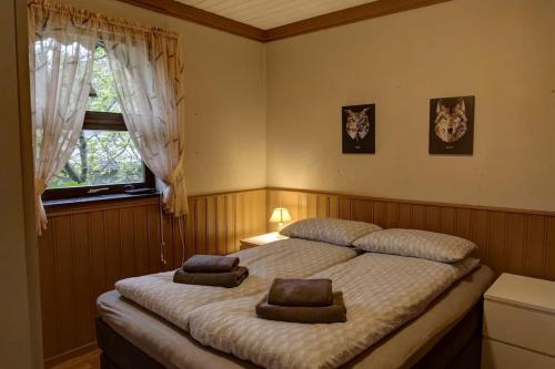 a bedroom with a bed with two pillows on it at Trollheimen - Senjatrollet in Finnsæter