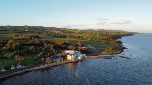 an aerial view of a house on an island in the water at Redcastle Hotel in Moville