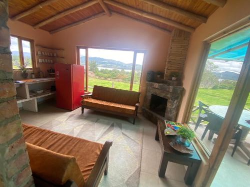 a living room with a couch and a fireplace at Rancho New Life Guatavita in Guatavita