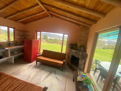 a living room with a couch and a fireplace at Rancho New Life Guatavita in Guatavita
