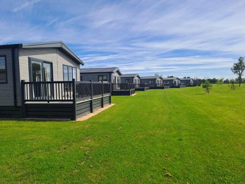 a row of houses in a field of grass at Addlethorpe Golf & Country Club, Ingoldmells in Addlethorpe