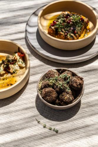 a table with three plates of food on it at Ela Tinos in Arnados