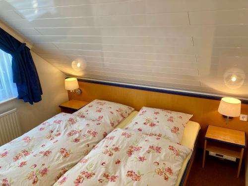 a bedroom with a bed and two pillows at Haus Reimann in Altenau