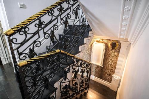 a stairway with a black and gold railing at SAFARI HOUSE - Wisła in Wisła