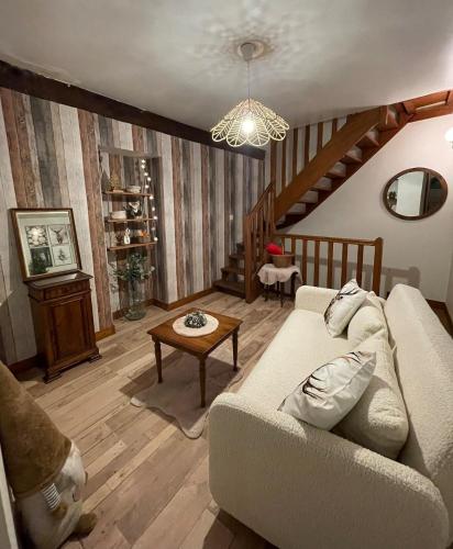 a living room with a couch and a table at "La petite maison" Triplex au centre ville - Les Terres du Roy in Avallon