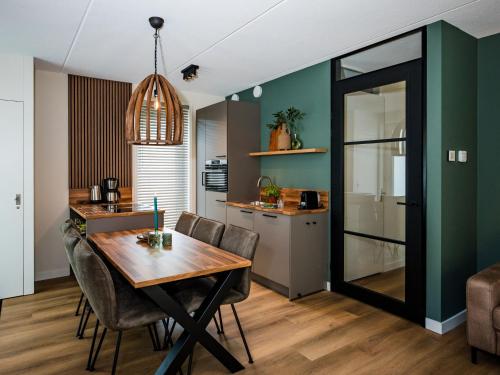a kitchen and dining room with a table and chairs at Holiday Home in Veluwe near National Park in Voorthuizen