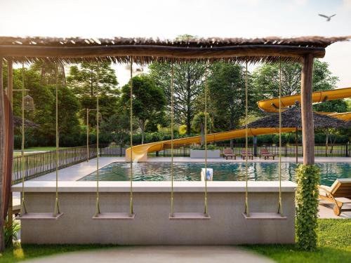 a swimming pool with a slide in a park at Holiday Home in Voorthuizen near Veluwe in Voorthuizen