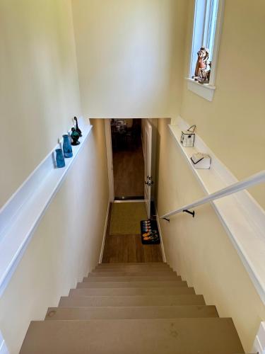 a stairway with a stair case and a window at Luxurious Basement Retreat in Charlottetown