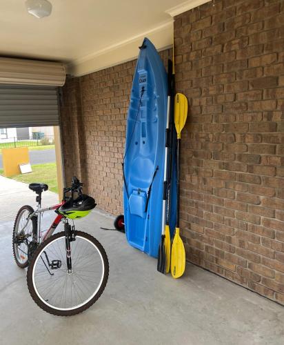 a bike is parked next to a brick wall at Cerca Del Agua family and pet friendly in Encounter Bay