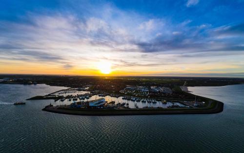 an aerial view of a marina at sunset at vakantiewoning aan zee en havens 24 in Yerseke