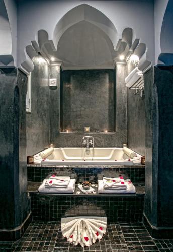a bathroom with a bath tub and a sink at RIAD DREAMS in Marrakesh