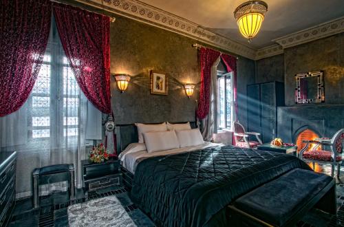a bedroom with a bed in a room with a fireplace at RIAD DREAMS in Marrakesh