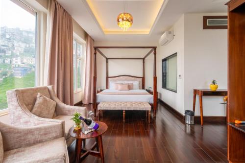a hotel room with a bed and a couch at The Orchid Shimla in Shimla