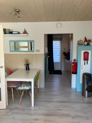 a kitchen and dining room with a table and chairs at Appartement Martina 22 in Vlissingen