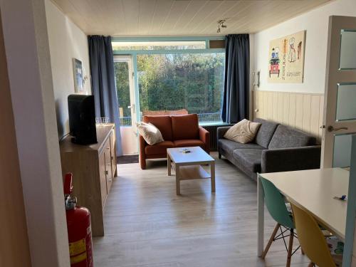 a living room with a couch and a table at Appartement Martina 22 in Vlissingen