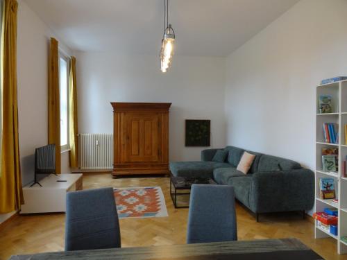 a living room with a couch and chairs at Fürstlich wohnen im Obergeschoss in Putbus